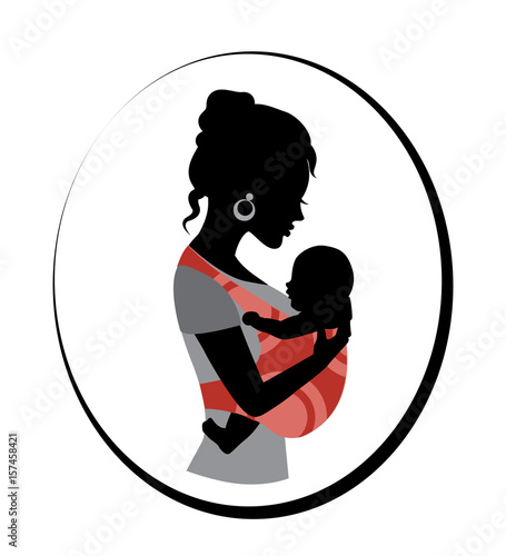 Silhouette of a woman holding a baby in a sling