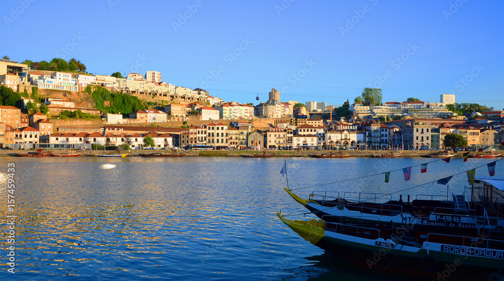 Boats in clear blue water during sunset, seen from Ribeira, Porto, Portugal