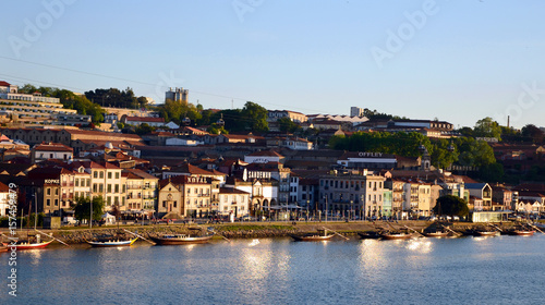 Reflection of the sun and boats at river Douro and city during Sunset, seen from Ponte Luis at Sunset - Porto, Portugal