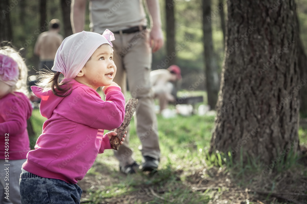 Playful child playing outdoors in summer forest during weekend holidays Playful child playing outdoors in summer forest during weekend holidays