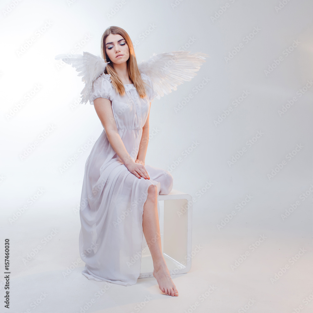 Young, wonderful blonde girl in the image of an angel with white wings. Young, wonderful blonde girl in the image of an angel with white wings.