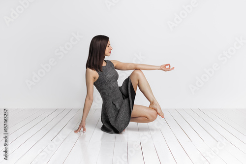 Young slim brunete woman in yoga class making beautiful asana exercises. photo