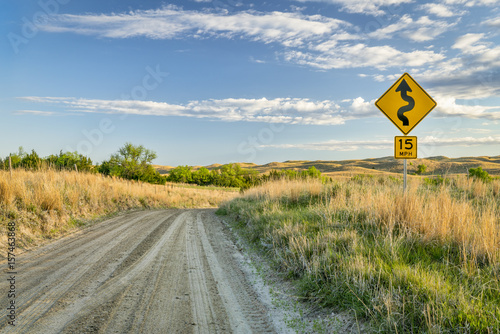 sandy ranch road descending into a valley of DIsmal RIver in Nebraska Sand Hills near Seneca, spring scenery