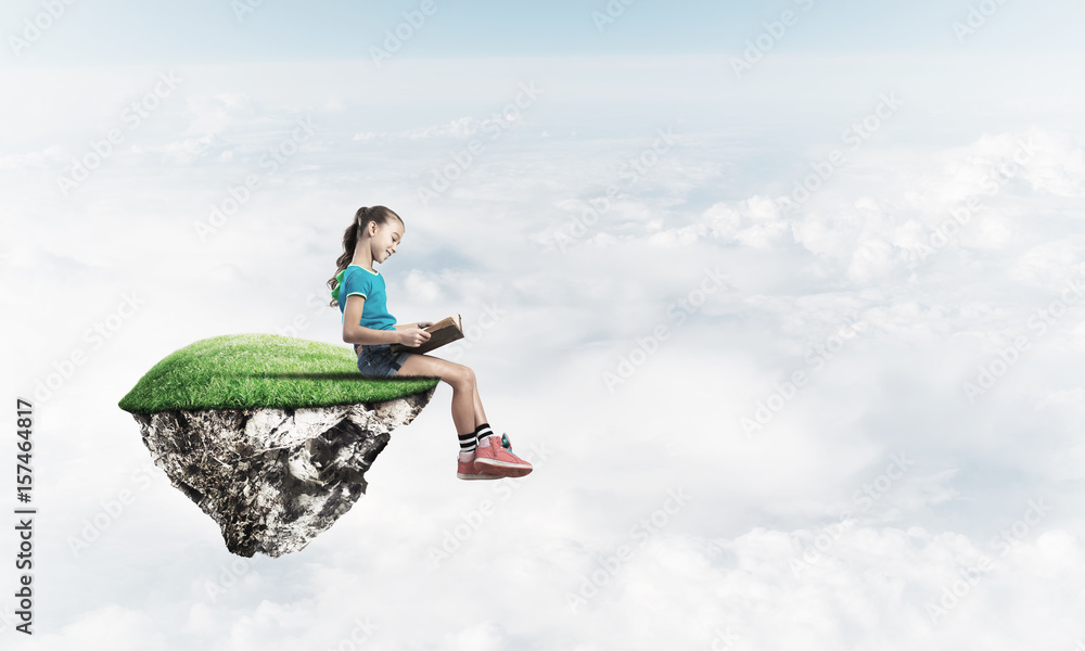 Concept of careless happy childhood with girl reading book