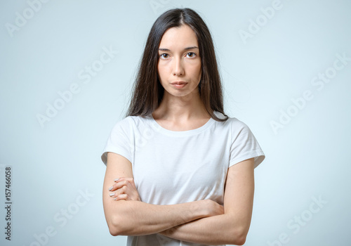 Portrait of beautiful young confident woman with serious expression