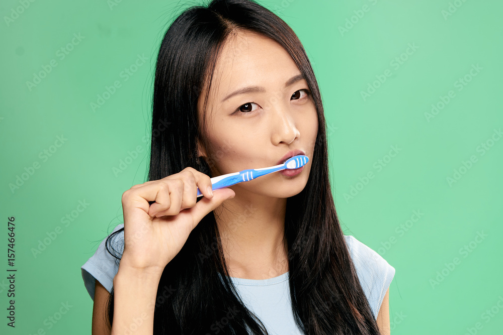 woman asian brushes teeth, care woman asian brushes teeth, care