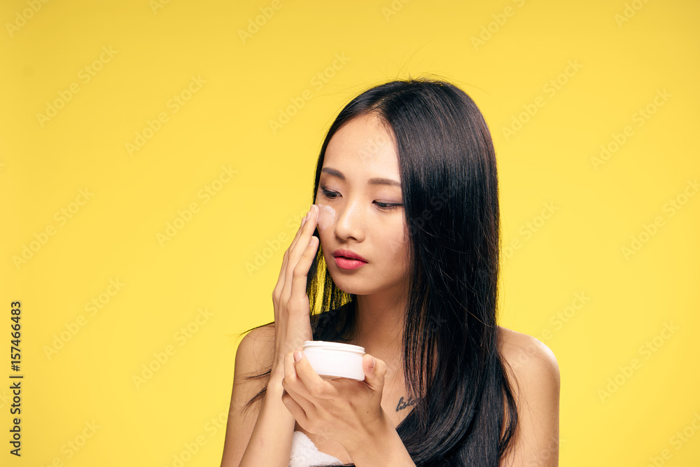 cream for caring for problem skin, Asian woman cream for caring for problem skin, Asian woman