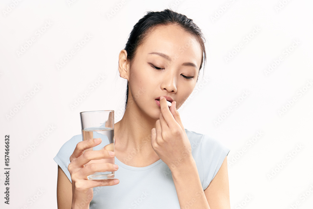 woman with a glass of water, pill, treatment woman with a glass of water, pill, treatment