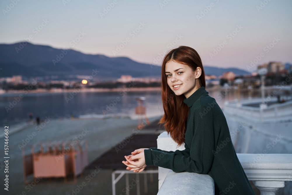 evening, sunset, fresh air, woman on the embankment near the sea