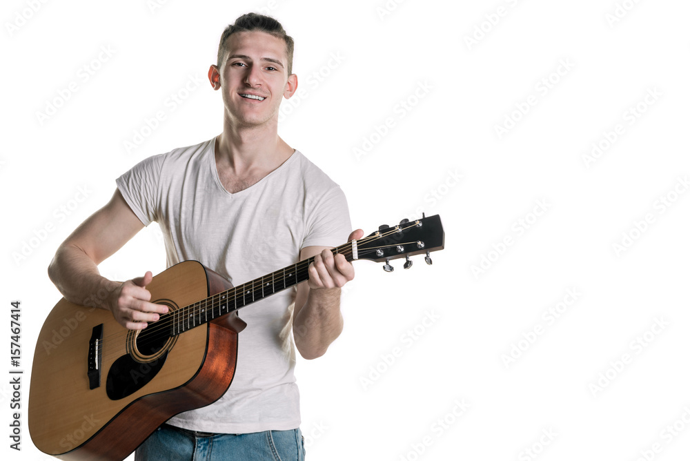 Music and creativity. Handsome young man in t-shirt playing on acoustic guitar. Horizontal frame Music and creativity. Handsome young man in t-shirt playing on acoustic guitar. Horizontal frame