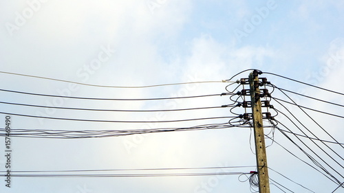 Electricity and utility pole and power lines in the blue sky