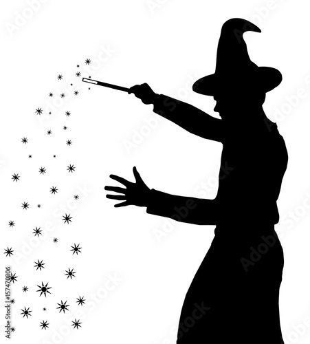 Silhouette of teenage boy wizard with hat creating magic