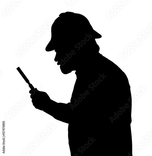 Silhouette of bearded man investigating with a magnifying glass and Sherlock hat