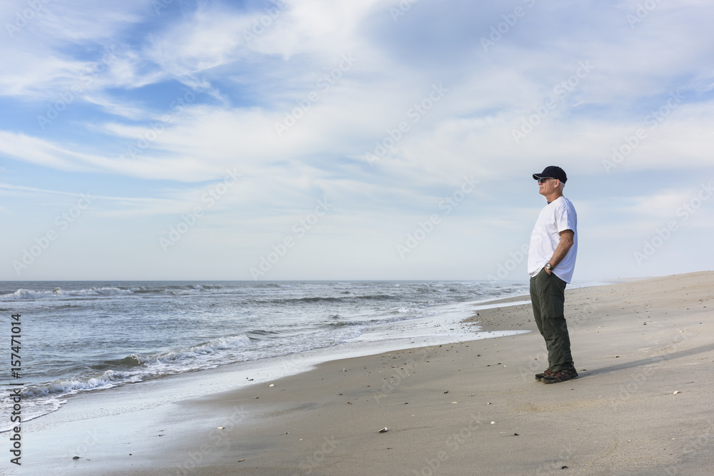 Mature Man Standing on Beach and Looking at Sea