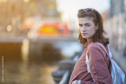 Pretty young woman at the river embankment