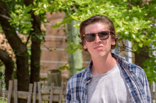 College student walking on campus with sunglasses