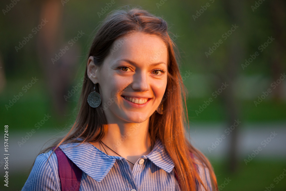 Beautiful young girl taking pictures in the forest. The girl with the camera. Tourist. Sunset. Beautiful young girl taking pictures in the forest. The girl with the camera. Tourist. Sunset.