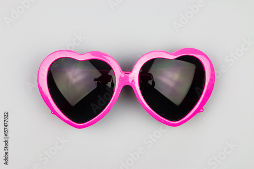 Heart-shaped sunglasses on a gray background