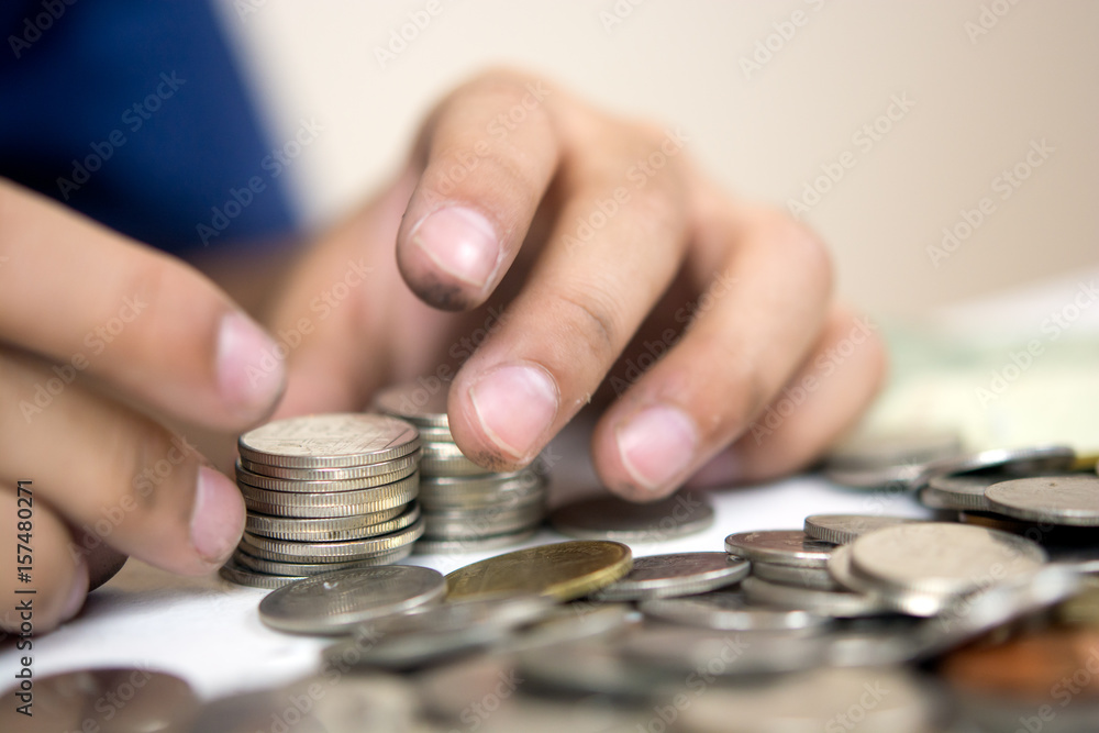 Blur coine and boy hand .selective focus on coine .money Blur coine and boy hand .selective focus on coine .money