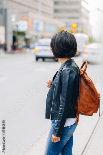 Stampa su tela Portrait of young girl woman with short dark hair bob style, in blue jeans and l