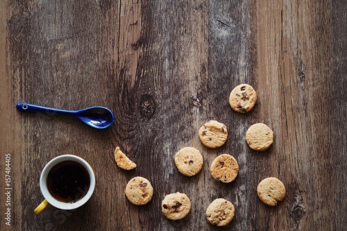 Coffee cup ,cookie and the opened book on wooden table background,copy space