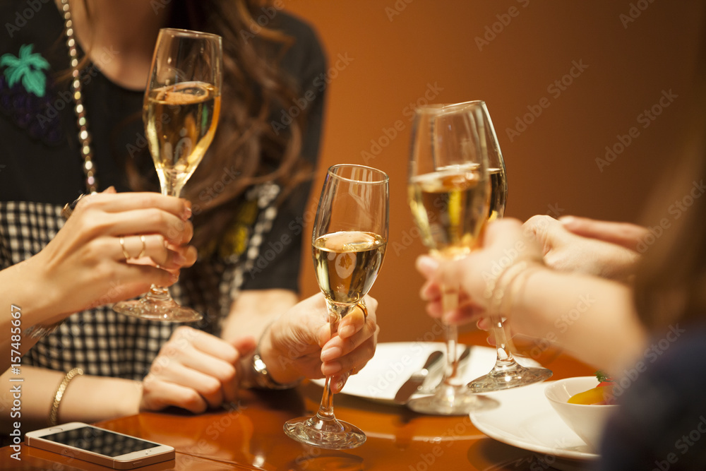 Four women are drinking in a luxurious restaurant with champagne Four women are drinking in a luxurious restaurant with champagne