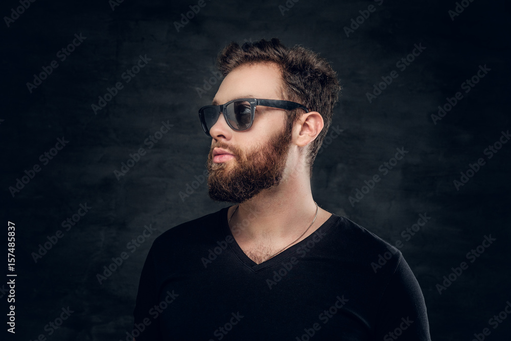 Fototapeta premium Stylish bearded male in sunglasses over grey background.