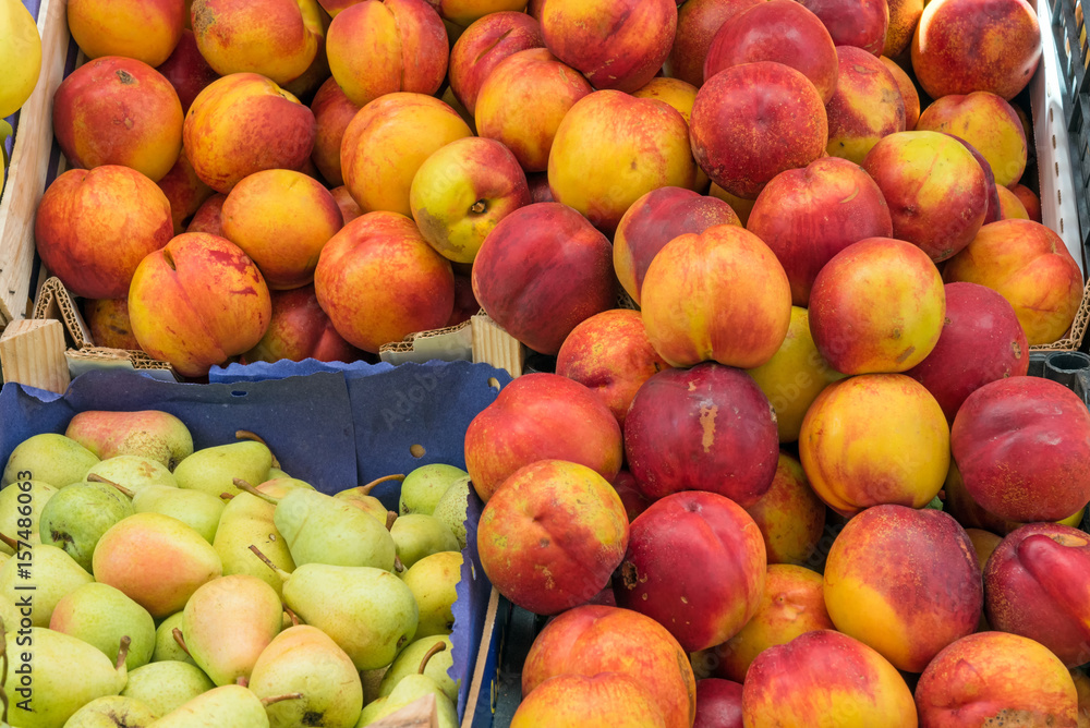 Nectarines and pears for sale at a market Nectarines and pears for sale at a market