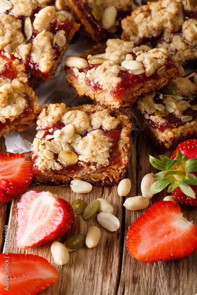 Fototapeta premium Peanut and Strawberry Jelly Oat Bar Squares close-up. Vertical