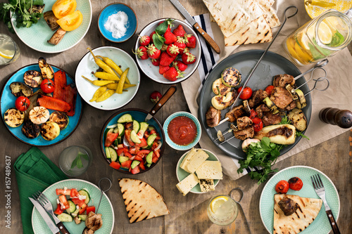 Shish kebab, various grilled vegetables, salad, lemonade, strawberries and snacks