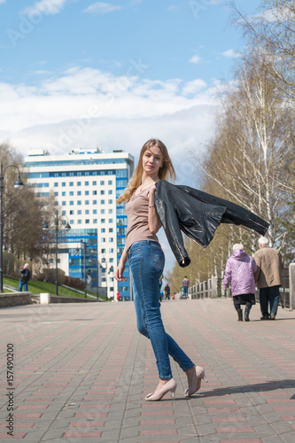 Girl with blond hair on the street of city