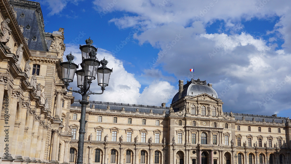 Photo of iconic Louvre Palace on a cloudy spring morning, Paris, France Photo of iconic Louvre Palace on a cloudy spring morning, Paris, France