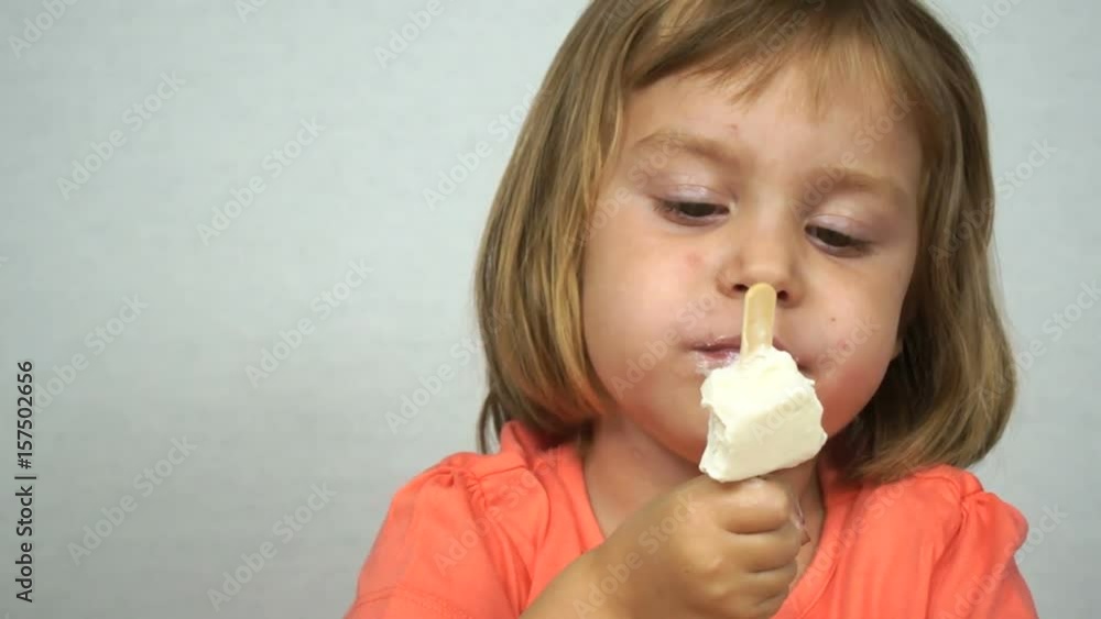 Funny girl 4-5 years old is eating ice cream. The child has a stained face. A series of footage, batch. Shooting on white background. Funny girl 4-5 years old is eating ice cream. The child has a stained face. A series of footage, batch. Shooting on white background.