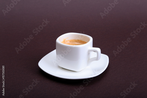 Classic espresso coffee in white cup isolated on dark background. Top View.