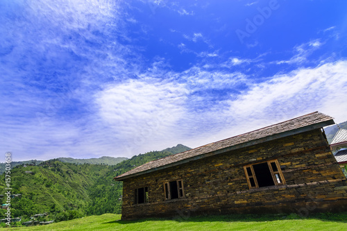 Idyllic and beautiful landscape with an old abandoned wooden house photo