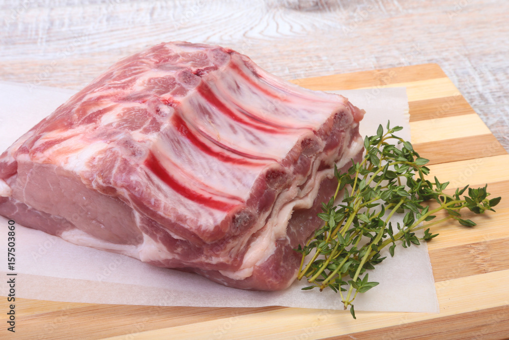Raw pork chops, spices and rosemary on cutting board. Ready for cooking. Raw pork chops, spices and rosemary on cutting board. Ready for cooking.