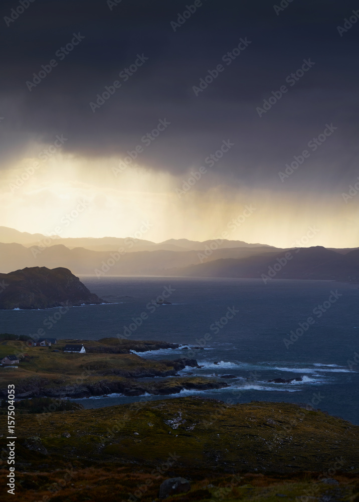 Heavy rain over coastal crofts at Loch Ewe, Scottish Highlands, Scotland, UK.