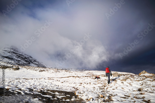 A hiker walking along the mountain path  route on Beinn Eighe, Scottish Highlands, Scotland, UK.