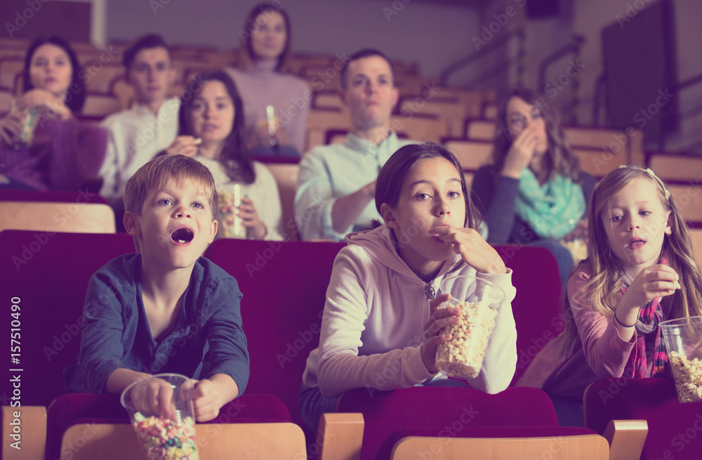 Enthusiastic audience attending movie night with popcorn