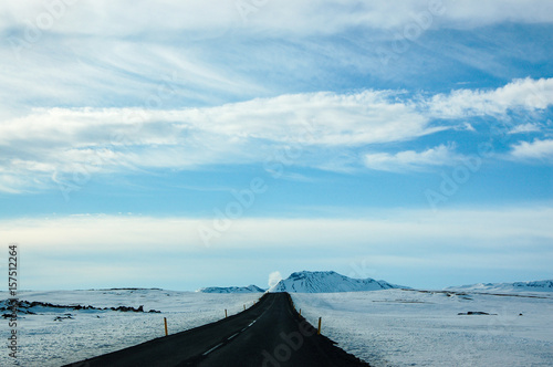 Lonely black road  snow  blue sky  Iceland