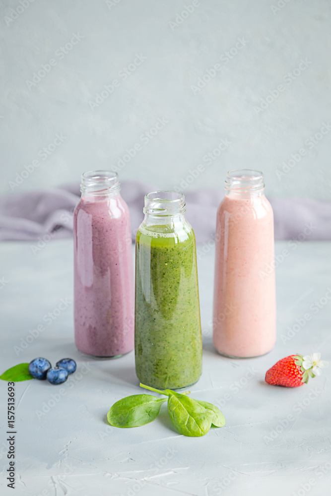 Variations of Smoothies in Bottles on Grey Background Healthy Drink Variations of Smoothies in Bottles on Grey Background Healthy Drink