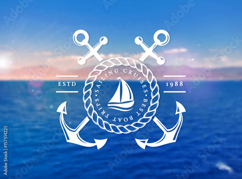 Sailing cruises logo on blurred sea background.