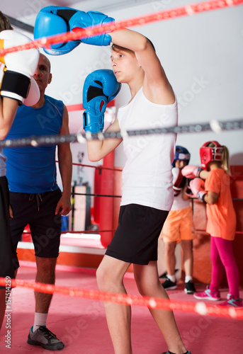 Children training on boxing ring