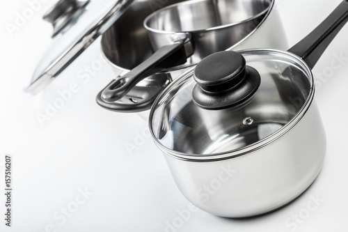 Stainless steel pots and pans isolated on white