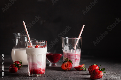 Milkshake of strawberries in a glass on the table