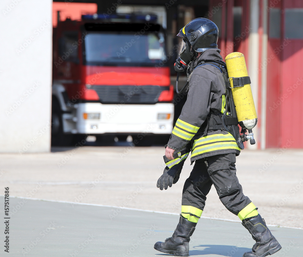 Firefighter with large oxygen cylinder and automatic respirator