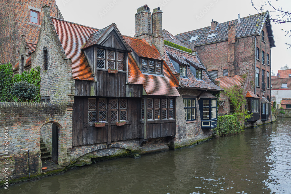 Beautiful view on canal with old picturesque houses with brick and wooden facades in historic part of Bruges (Brugge), Belgium