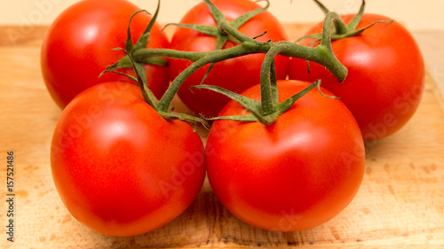 top view of red tomatoes on wooden table