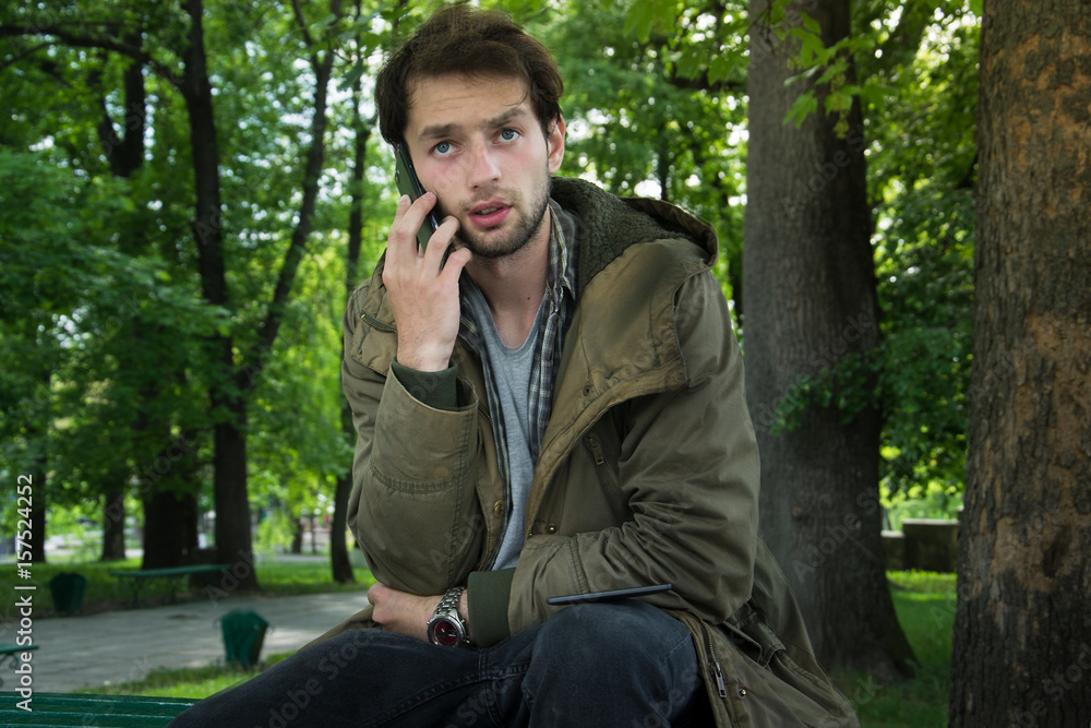 Portrait of young hipster man talking on mobile phone.