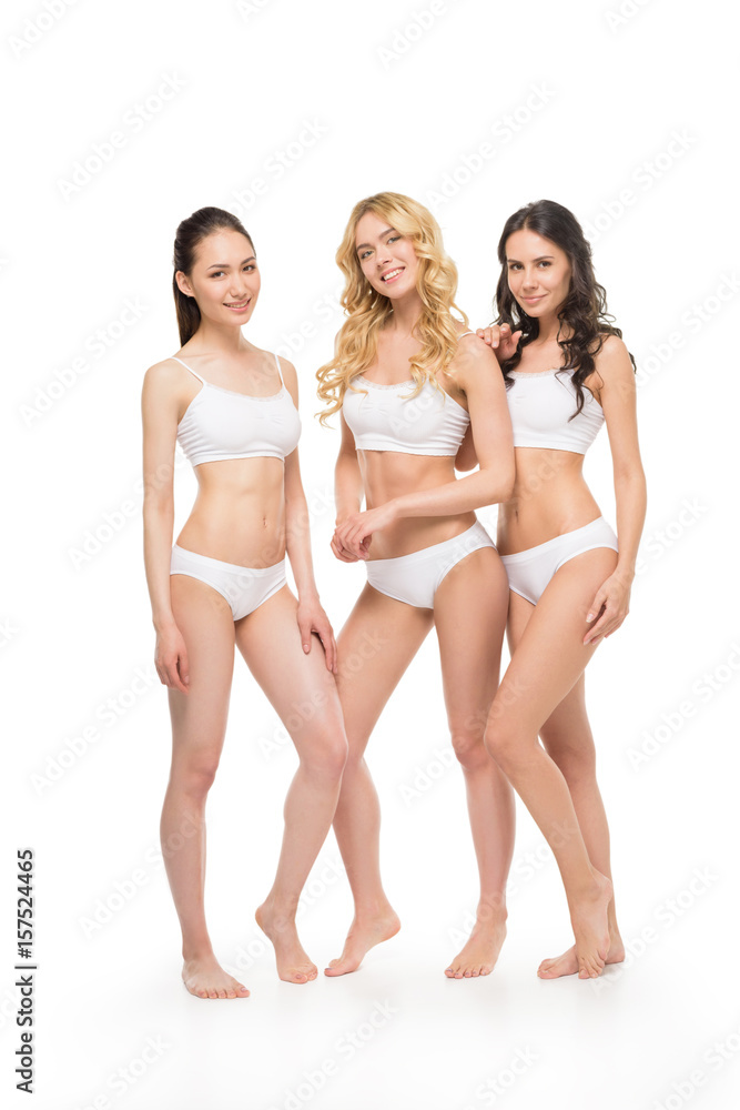 group of smiling women with slim bodies in lingerie posing isolated on white group of smiling women with slim bodies in lingerie posing isolated on white